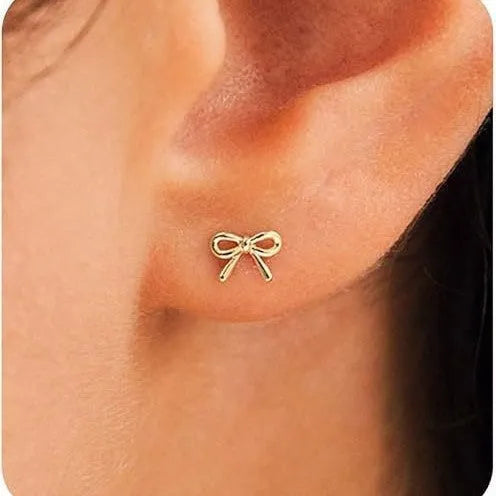 Women's electroplated zinc alloy bow and cross stud earrings in gold and silver, geometric shape.