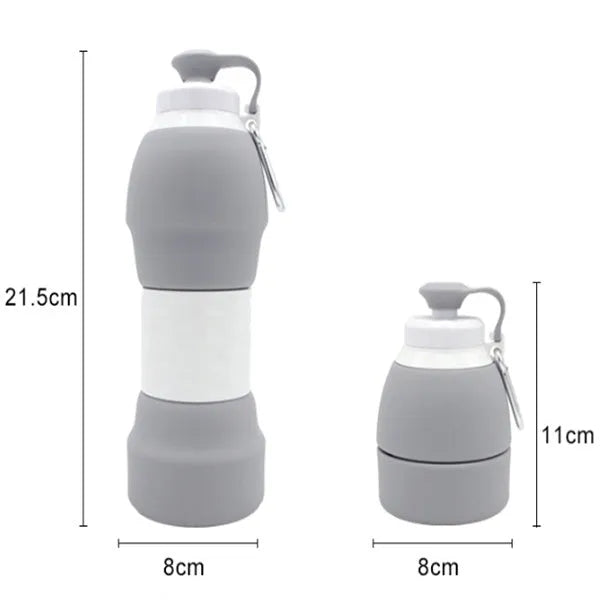 Silicone folding water bottle 580ml in blue, collapsed and full size, with cap, on outdoor background