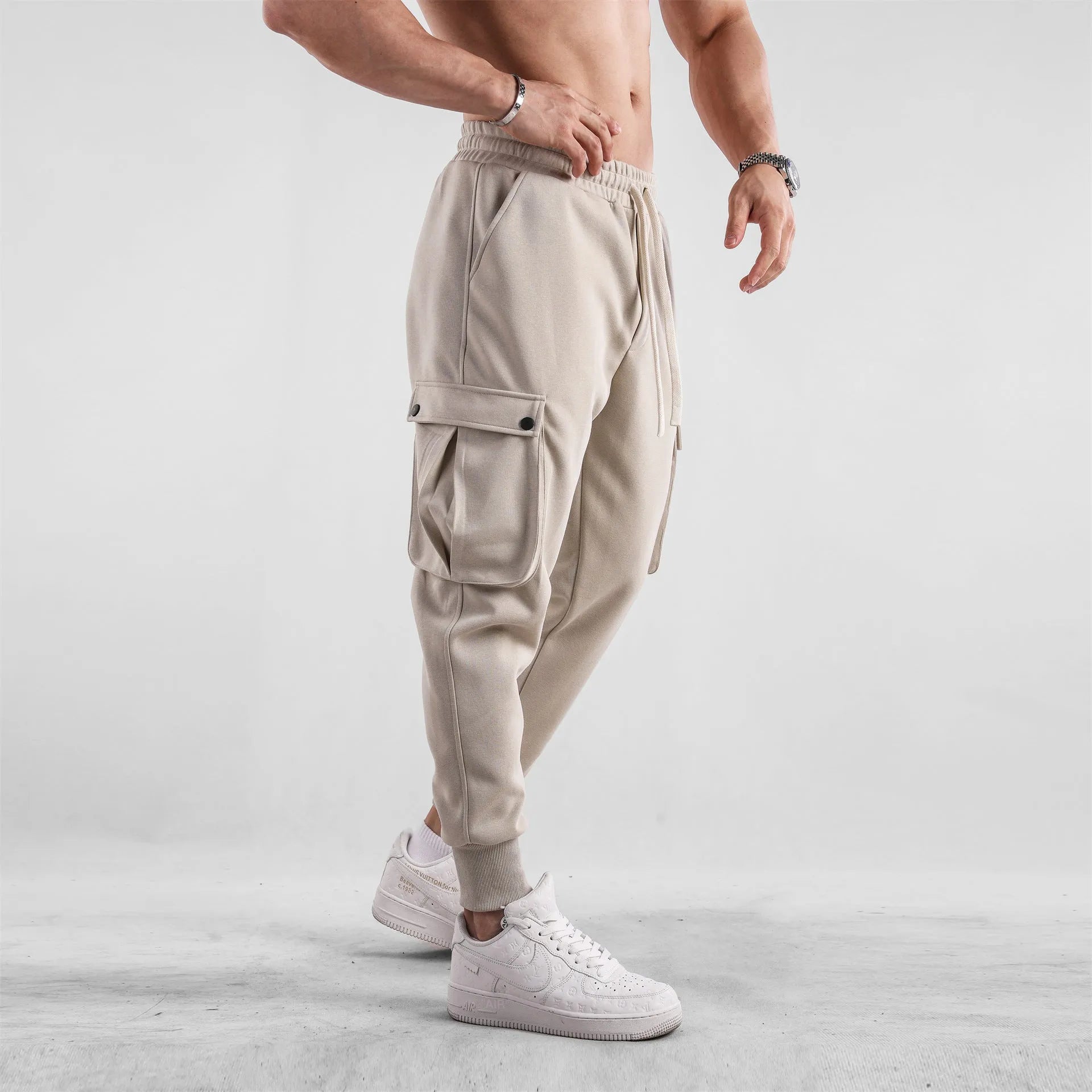 Men's loose cotton trousers with multiple pockets and adjustable ankle ties in solid colour options