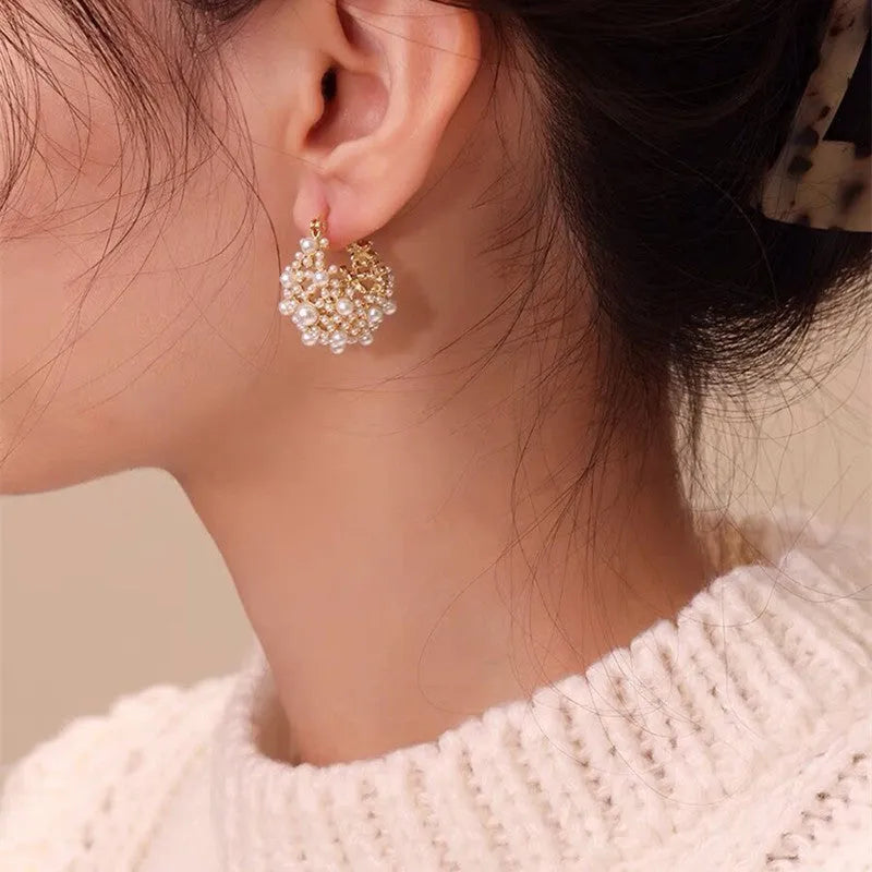 Gold copper drop earrings with small rice-shaped pearl inlay in a flower basket shape for women