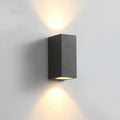 Modern aluminium and glass LED wall lamp in a black finish with silicone rubber trim.