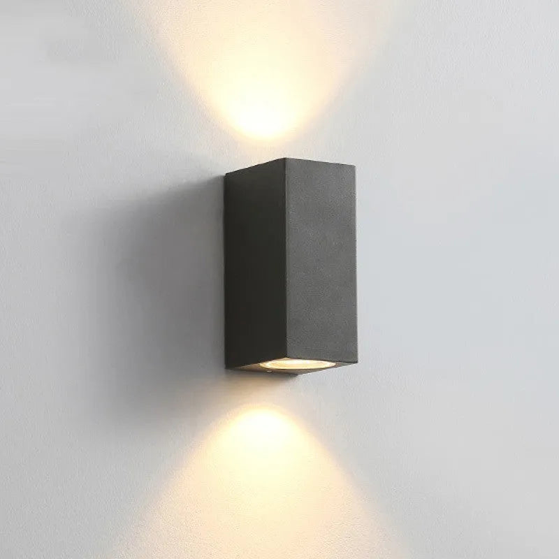 Modern aluminium and glass LED wall lamp in a black finish with silicone rubber trim.