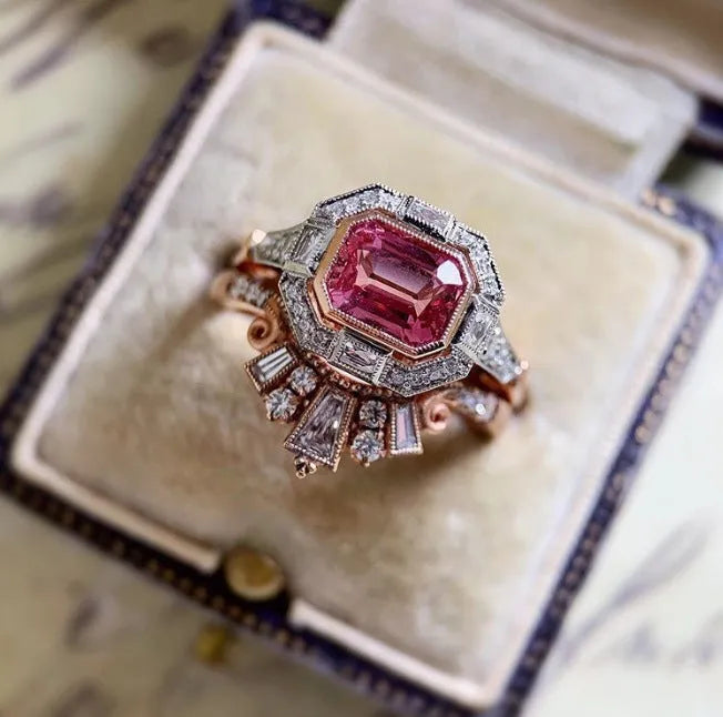 Rose gold colour women's fashion ring with geometric shape and ruby design elements in retro style