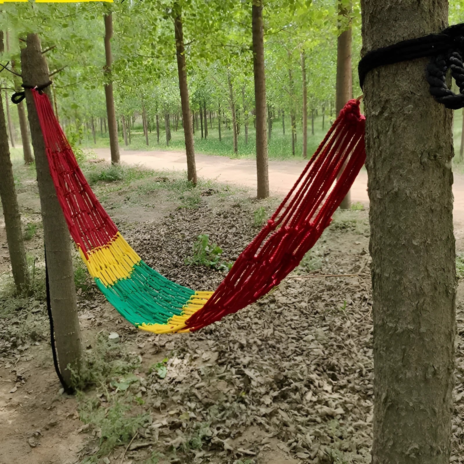 Nylon rope mesh hammock hanging between trees with bold weave pattern, showing 1.1m width