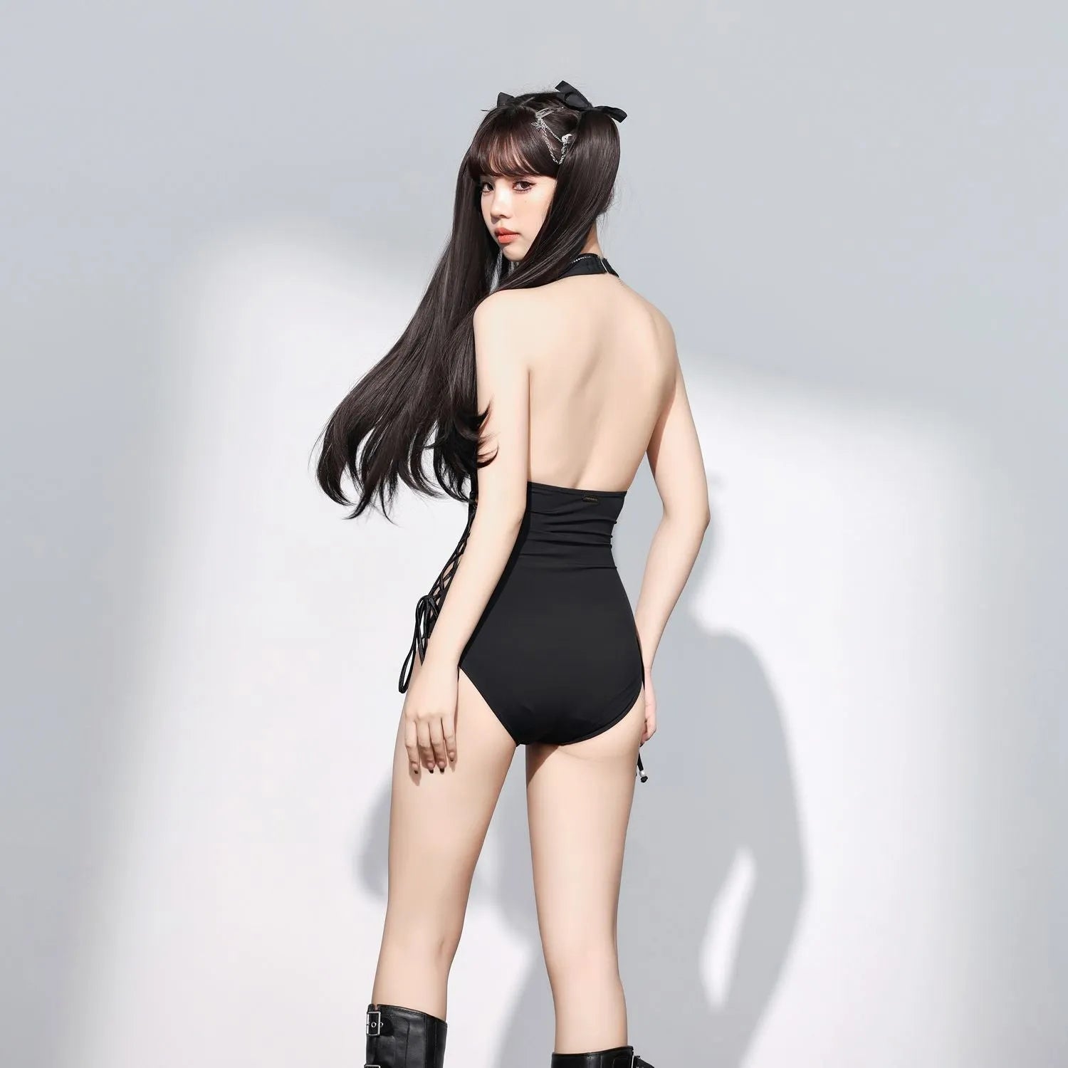 Women's V-neck hollow strap niche one-piece swimsuit in black polyester on a model