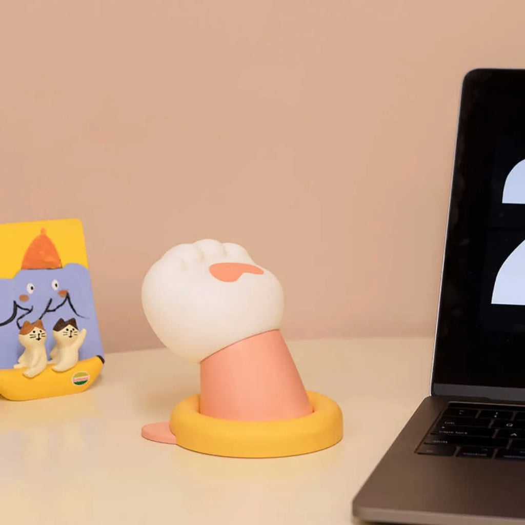 Cat paw rechargeable tap lamp with three brightness levels on a nightstand