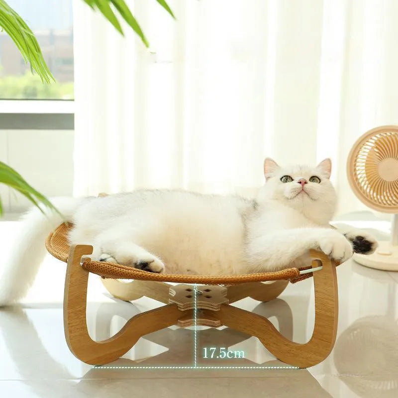 Brown woven rattan pet hammock bed for cats and dogs on a cool mat.