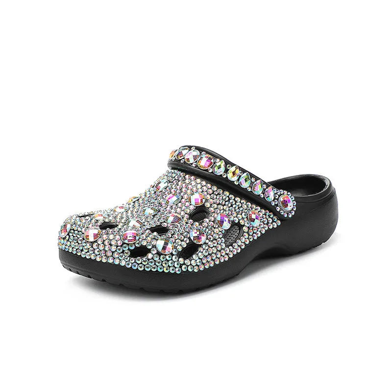 Black platform sandals for women with rhinestone decoration and a hole design upper on a white background.