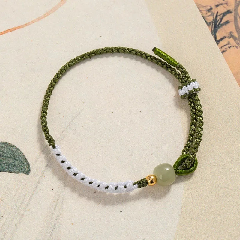 Chinese bracelet with Hetian Jade bead, sterling silver fittings, and adjustable coloured cord strap