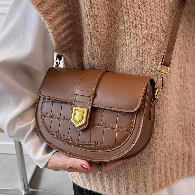 French one shoulder saddle bag in medium-soft PU with lock and stone pattern, available in black, brown, beige, and coffee