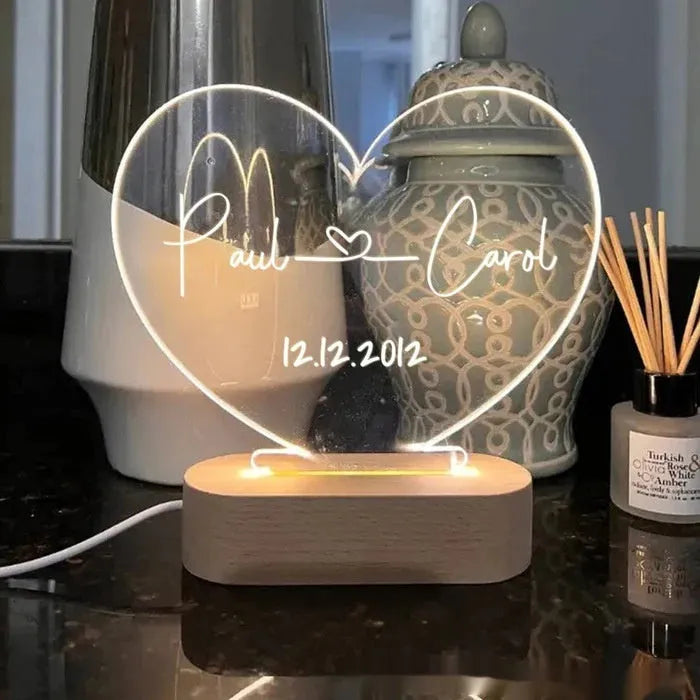 Custom acrylic LED night light displaying engraved names and dates on clear 20cm by 11.5cm panel
