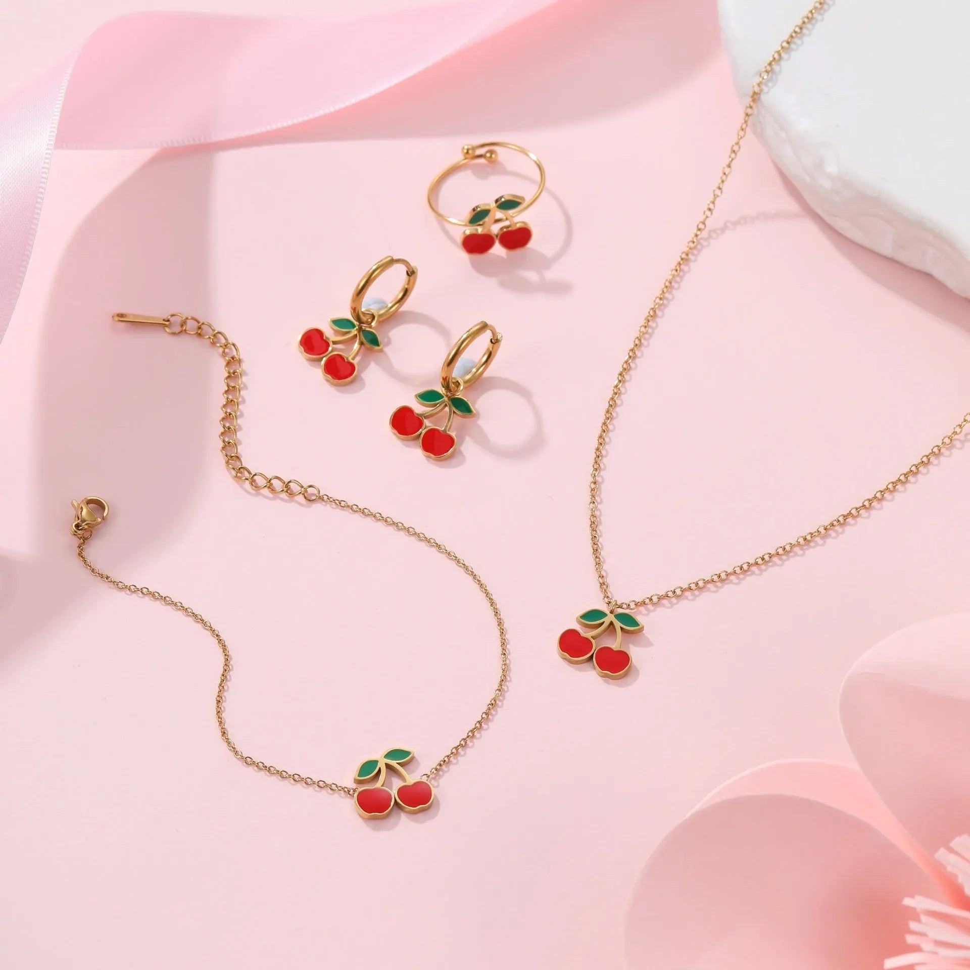 Complete cherry jewellery set with stainless steel necklace, bracelet, earrings, and ring featuring 18K electroplating