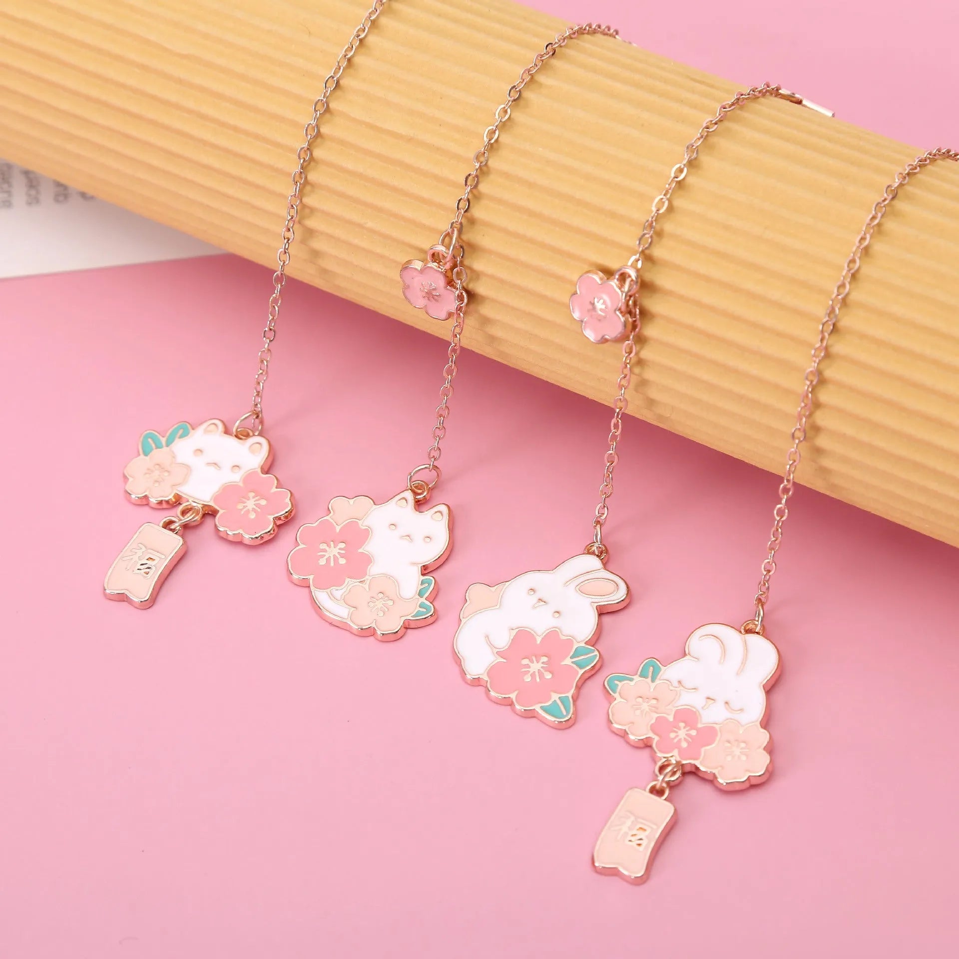 Creative cartoon metal pendant bookmark with cute cherry cat design in sakura style on white background