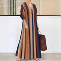 Camel coloured knitted polyester dress with vertical stripes, V-neck, long sleeves, and an A-line skirt.