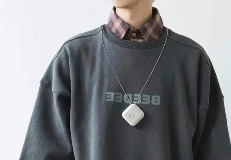 Mini USB portable air purifier necklace in blue colour, showing wearable design and single button.