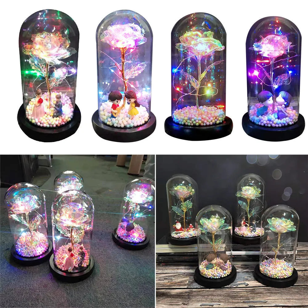 Gold artificial rose inside glass dome with LED lights on black base for home display