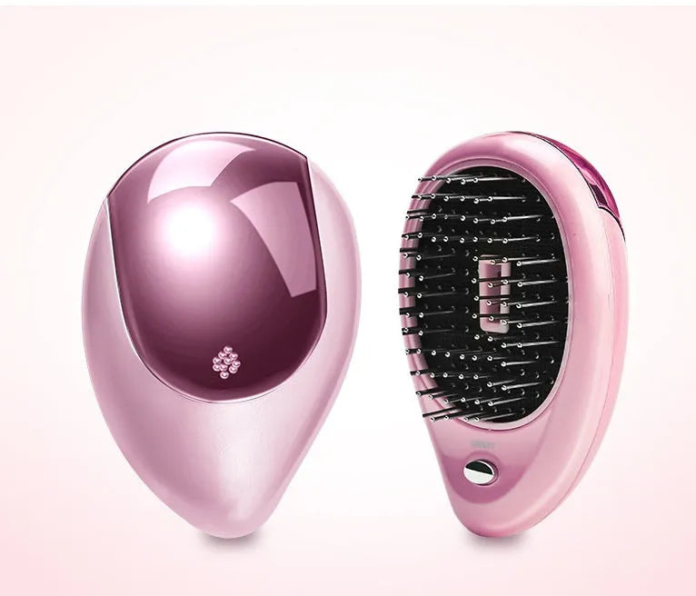 Pink electric sound wave vibration magnetic massage comb with ergonomic handle and negative ion function