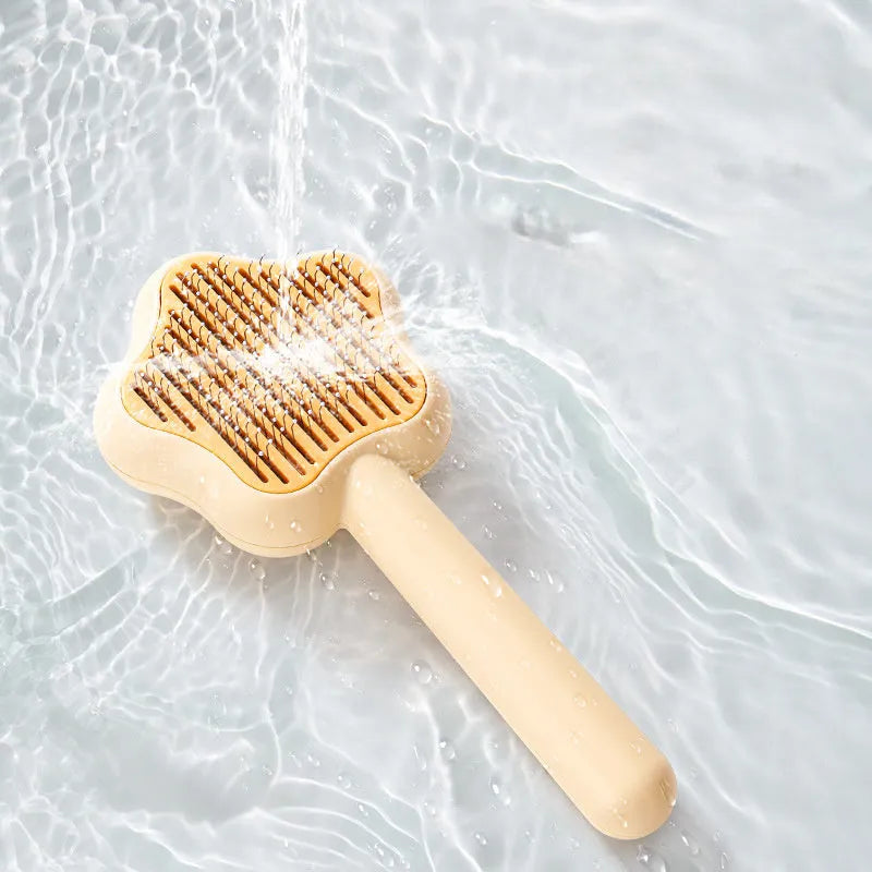 Green self-cleaning stainless steel pet comb for grooming cats and dogs on a white background
