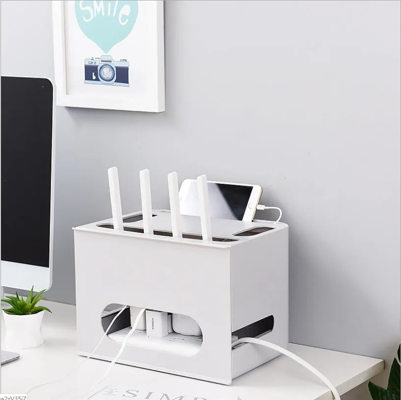 Plastic wireless router storage box in grey, with cable openings, for organising home networking equipment