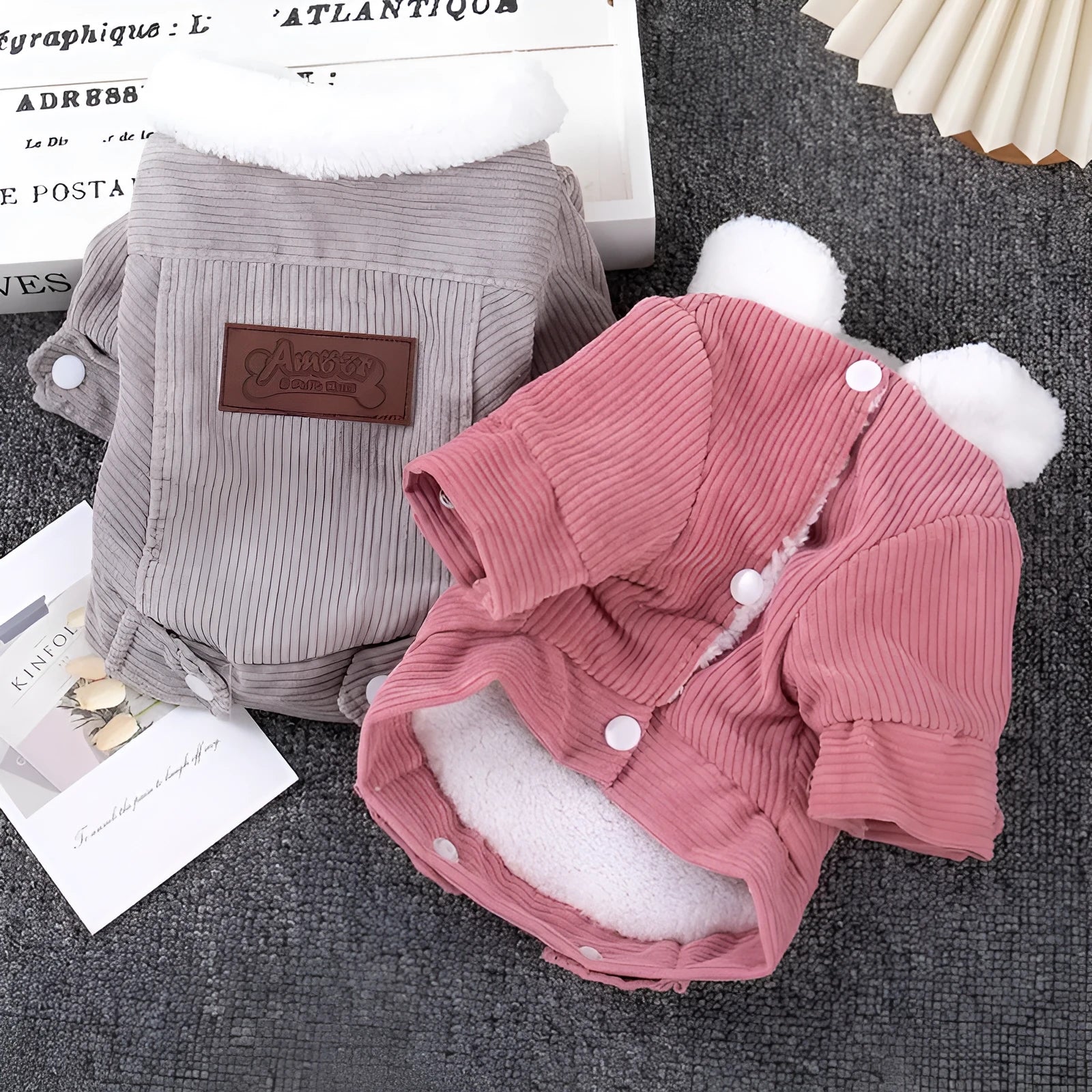 Lambswool fleece-lined dog vest in grey or pink, shown on a pet, for autumn and winter warmth.