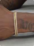 Gold electroplated unisex tennis bracelet on titanium steel with hip hop style and artificial gemstones.