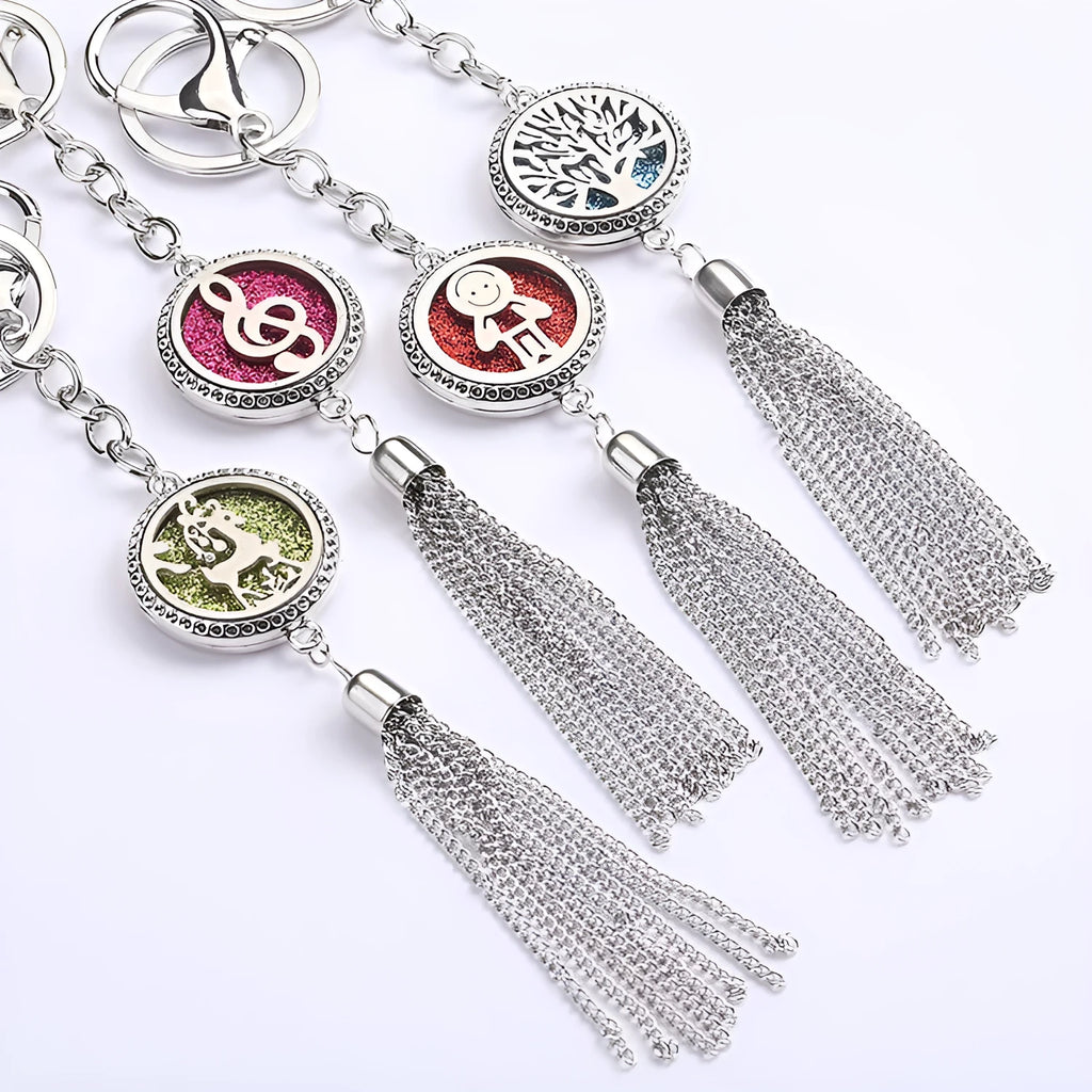 Silver alloy tassel aromatherapy car pendant with long chain on a coloured background.