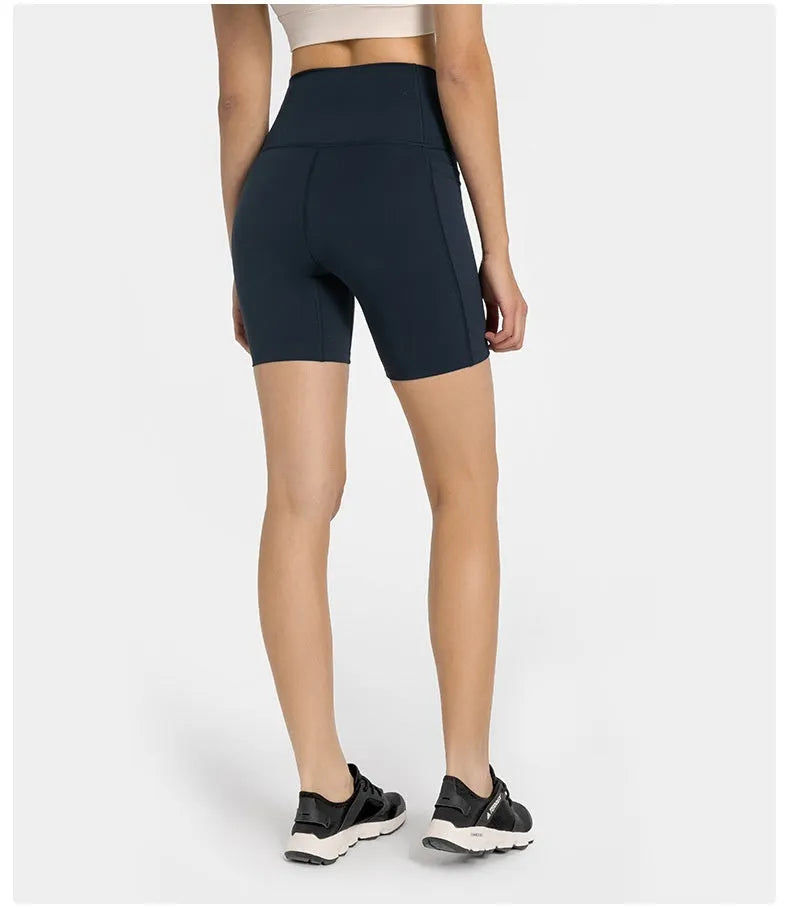 Women's tight-fitting mid-thigh sports shorts in grey lake green for fitness.