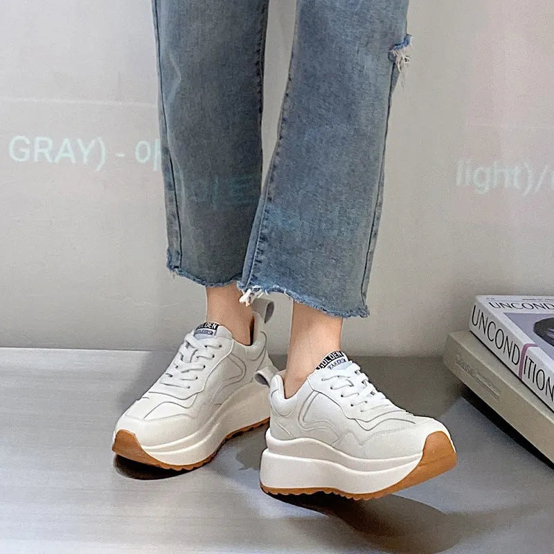 Beige women's low-top leather casual shoes with cross strap and English muffin heel on a white background.