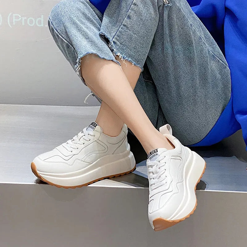 Beige women's low-top leather casual shoes with cross strap and English muffin heel on a white background.