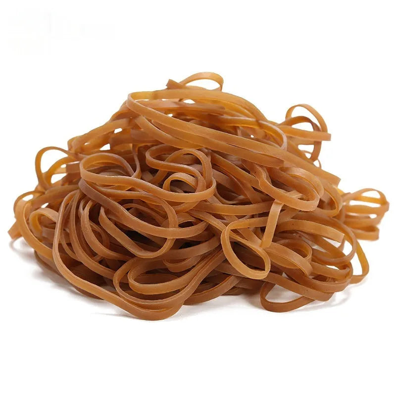 Circular natural rubber rings in natural colour on a surface in a 500g bulk bag