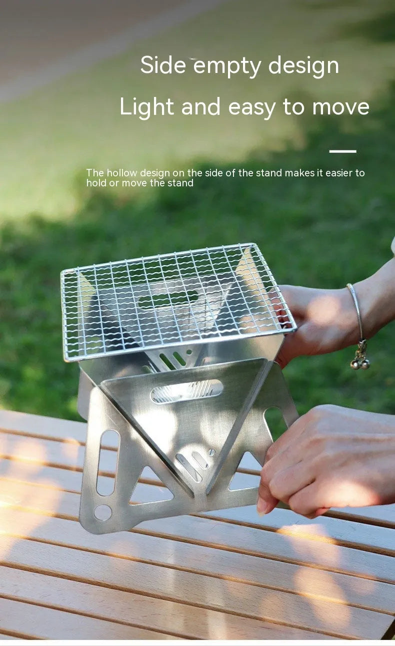 Large stainless steel folding barbecue oven for outdoor cooking, shown with its storage bag.
