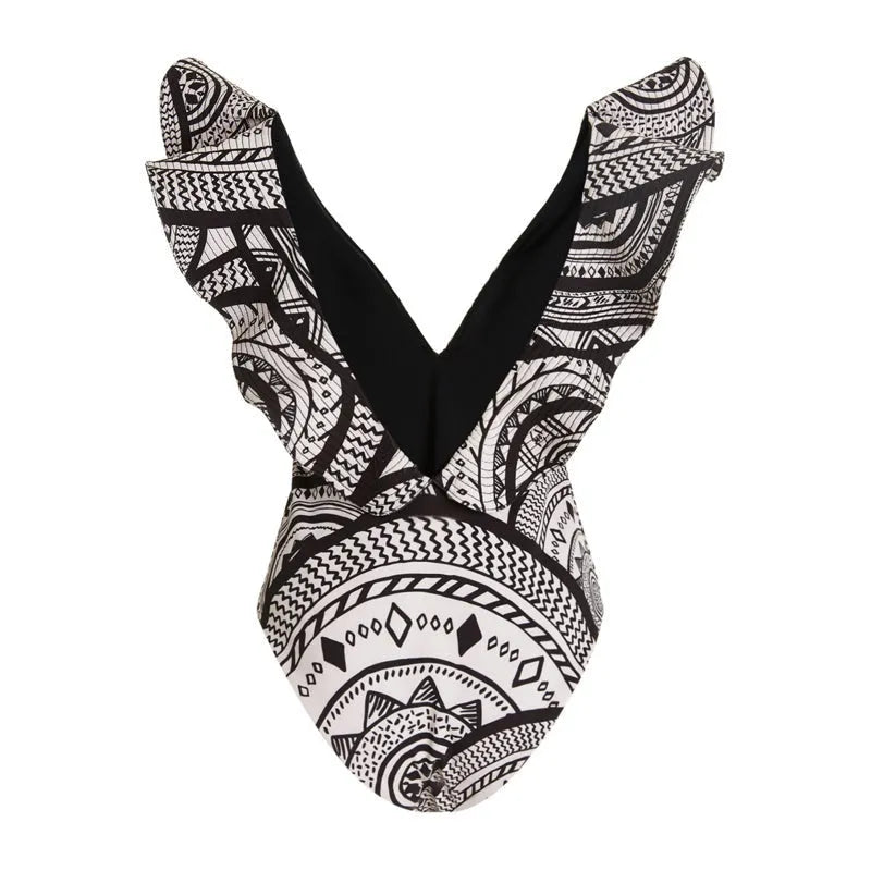 Women's vintage printed one-piece swimsuit with deep V neckline and ruffles, shown with matching wrap skirt.