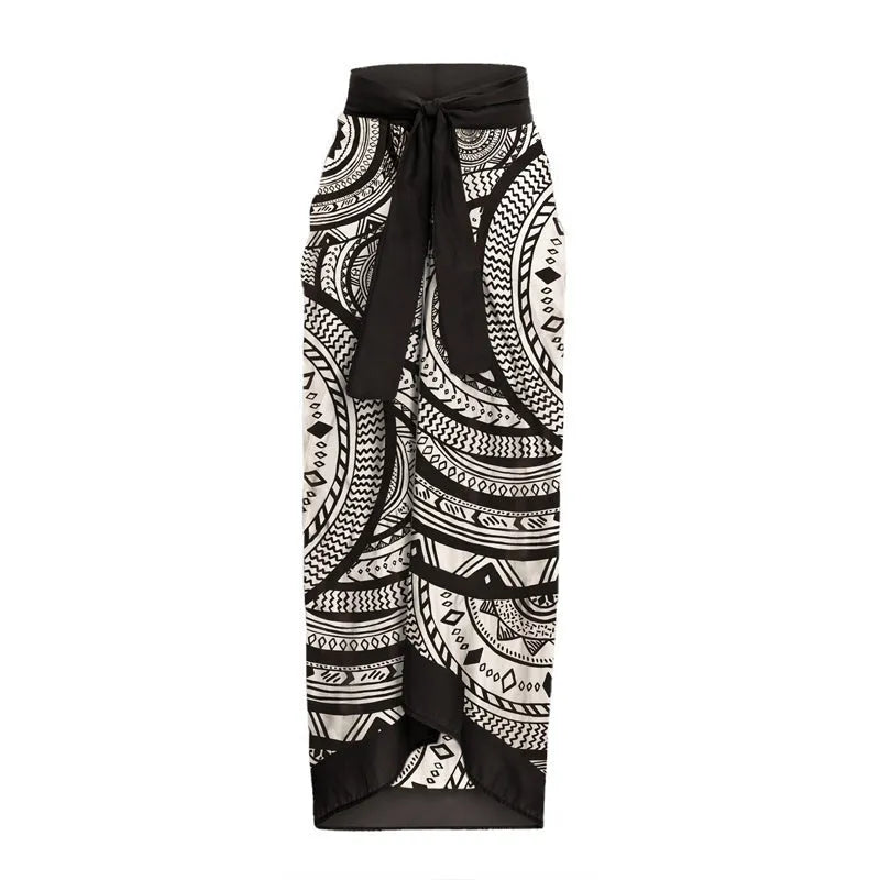 Women's vintage printed one-piece swimsuit with deep V neckline and ruffles, shown with matching wrap skirt.