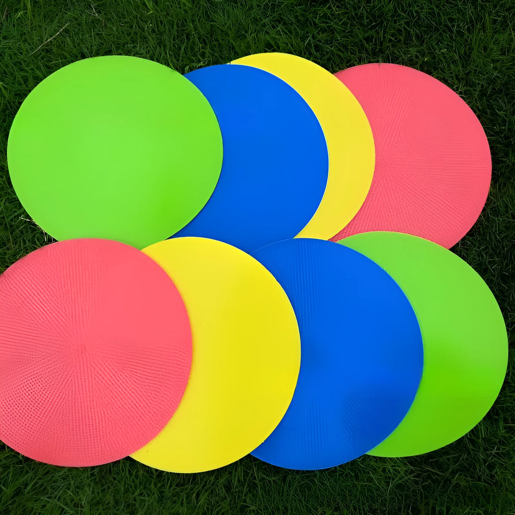 Yellow flexible TPE football training target disc, 23cm diameter, lying flat on grass.