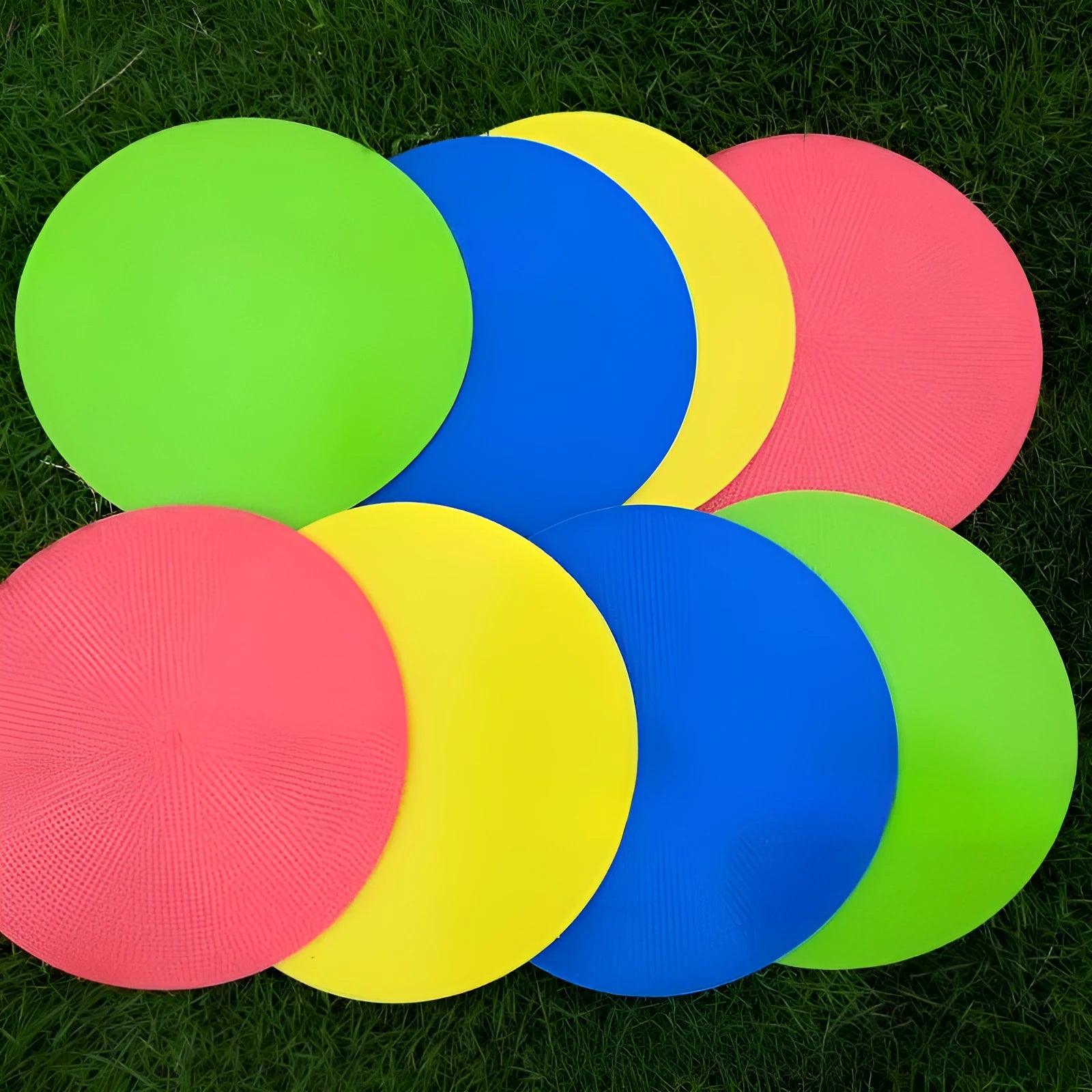 Yellow flexible TPE football training target disc, 23cm diameter, lying flat on grass.