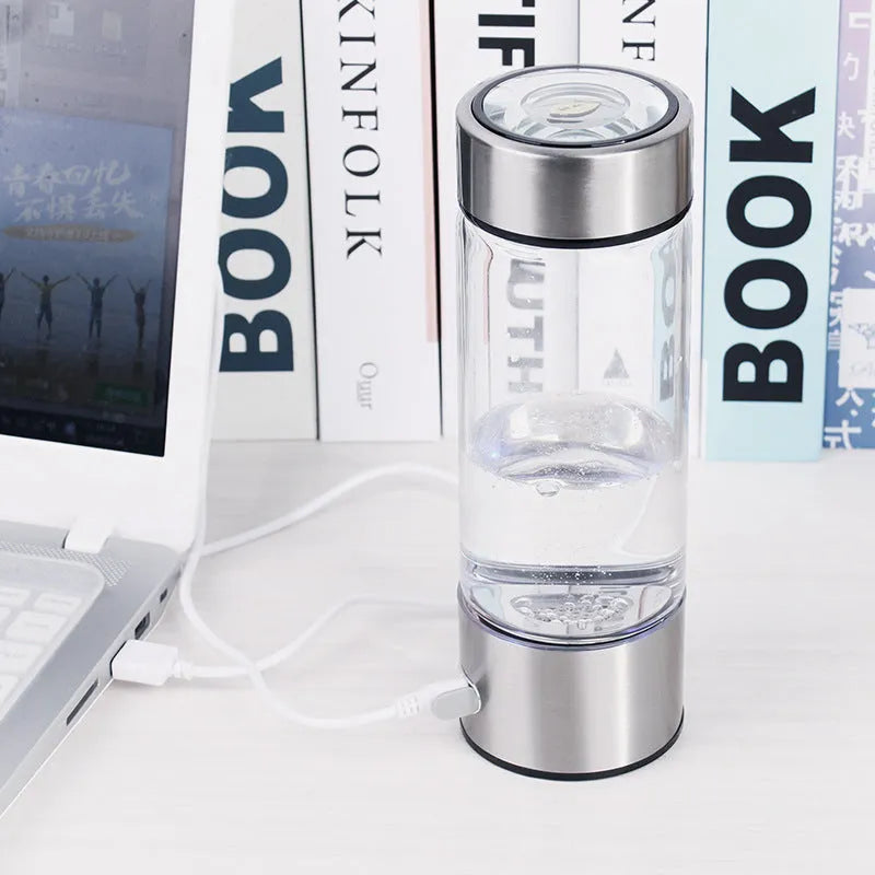 Hydrogen water bottle in silver with electric base, borosilicate glass body, 21.5cm tall, 401-500ml capacity