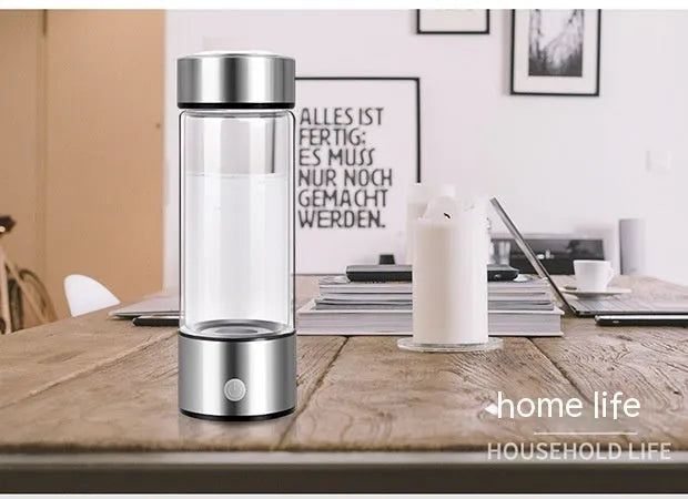 Hydrogen water bottle in silver with electric base, borosilicate glass body, 21.5cm tall, 401-500ml capacity