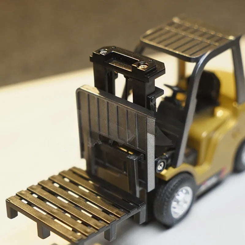 Alloy remote control engineering vehicle set with dump truck, excavator, and small forklift on a table
