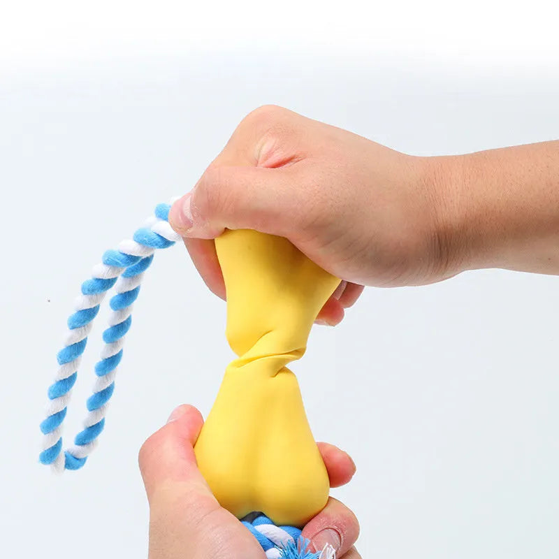 Red porous bone rope knot dog toy with treat-holding centre on white background
