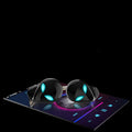 Creative Outer T8 Starman black and white alien design wireless earbuds with LED lights next to charging case.