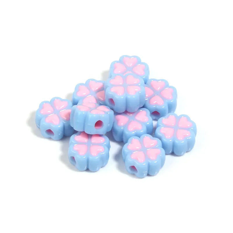 Acrylic four-leaf clover craft beads with love pattern in mixed colours showing frosted finish