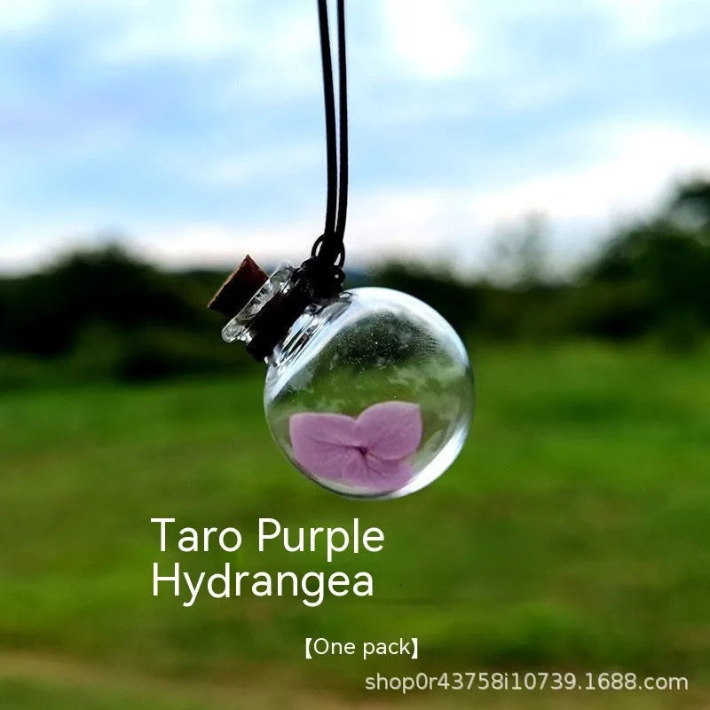 Glass preserved flower car pendant in fire extinguisher shape with pink hydrangea blooms, 28mm diameter