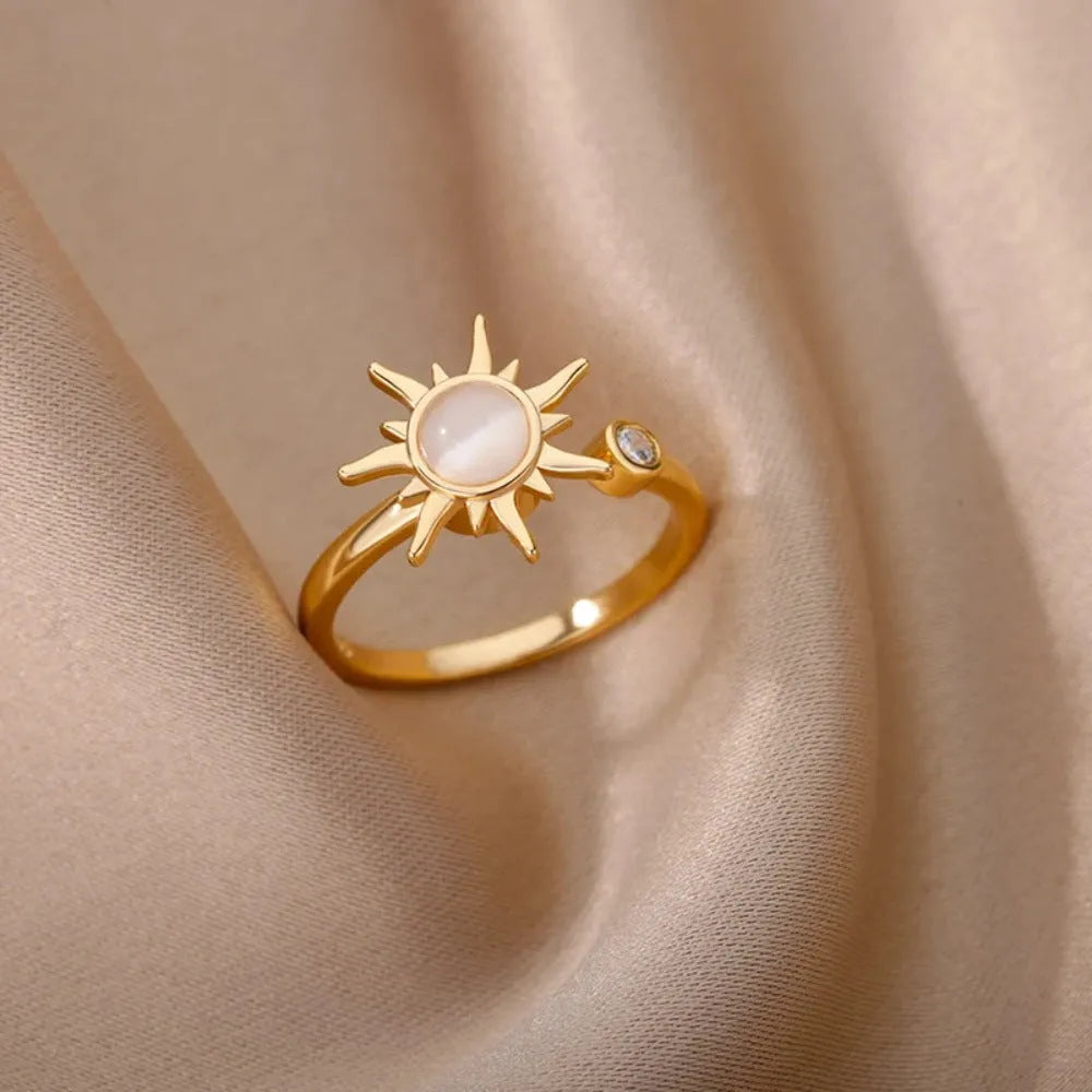 Simple gold adjustable spinner ring with rotating geometric component on a finger.