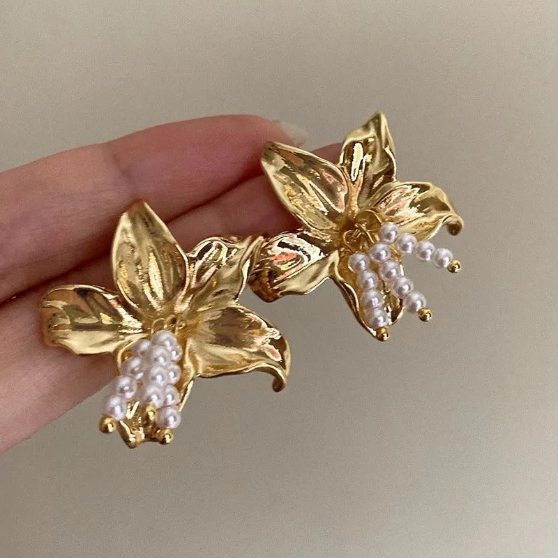 Gold H1795 metal flower earrings with pearl design and Seiko treatment
