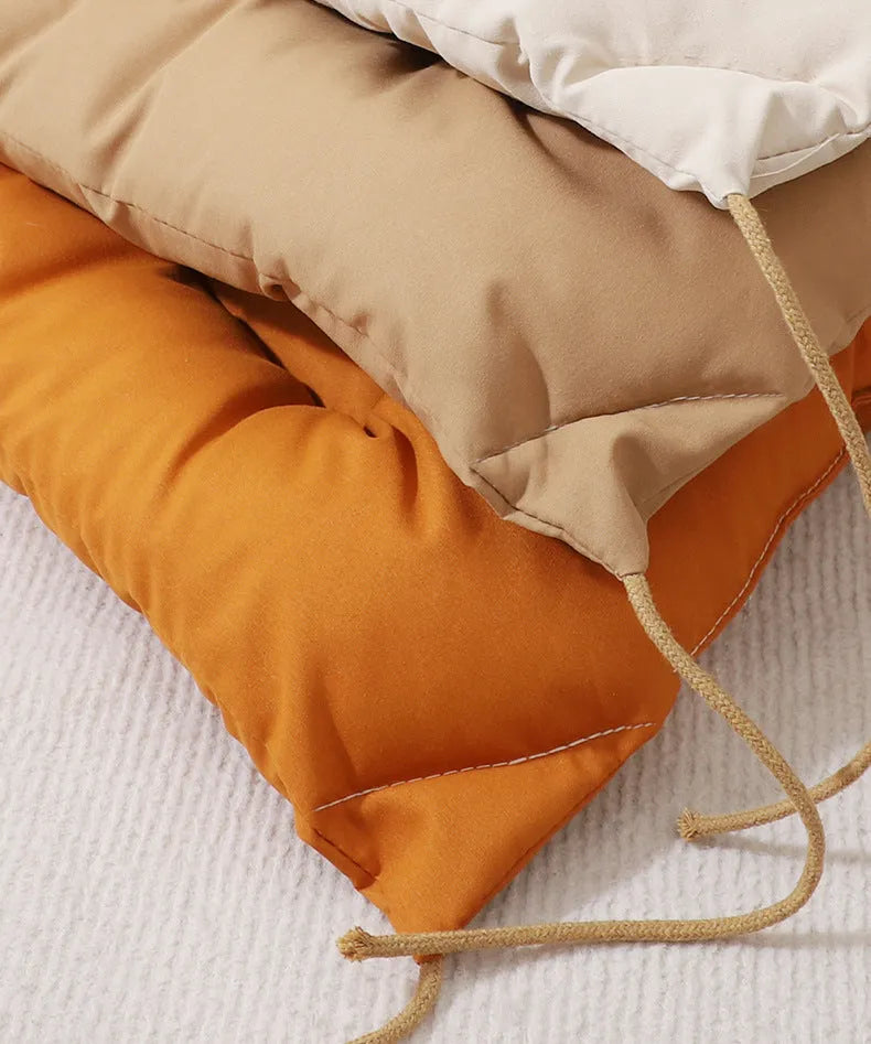 Beige cage cushion tied in a wire dog crate with soft padding for small pets
