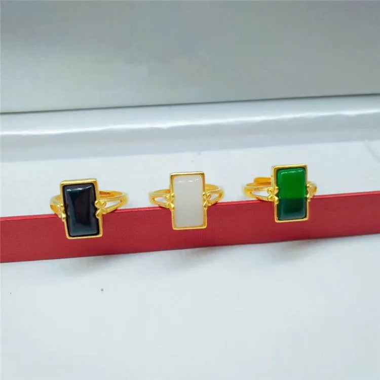 Adjustable brass gold-plated ring with electroplated gemstone inlay showing black, green and white colour options