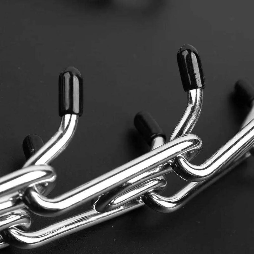 Stainless steel adjustable dog prong training collar with rubber comfort tips on a link.
