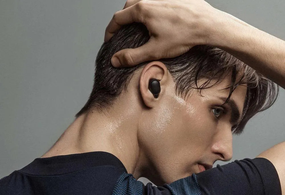 Redmi AirDots True Wireless black earbuds and charging case on a white background.