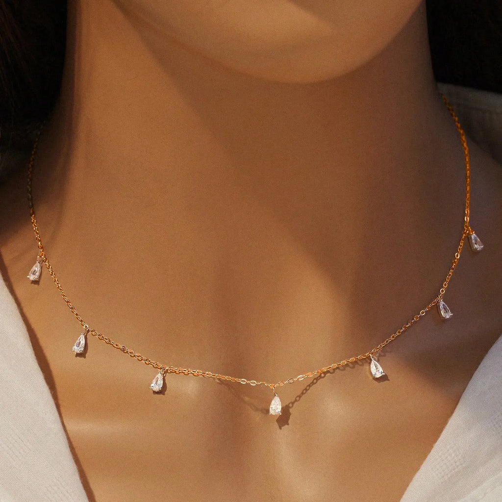 Silver drop-shaped artificial zircon necklace on an O-chain with triangular detail, showing rose gold and golden yellow colour options.