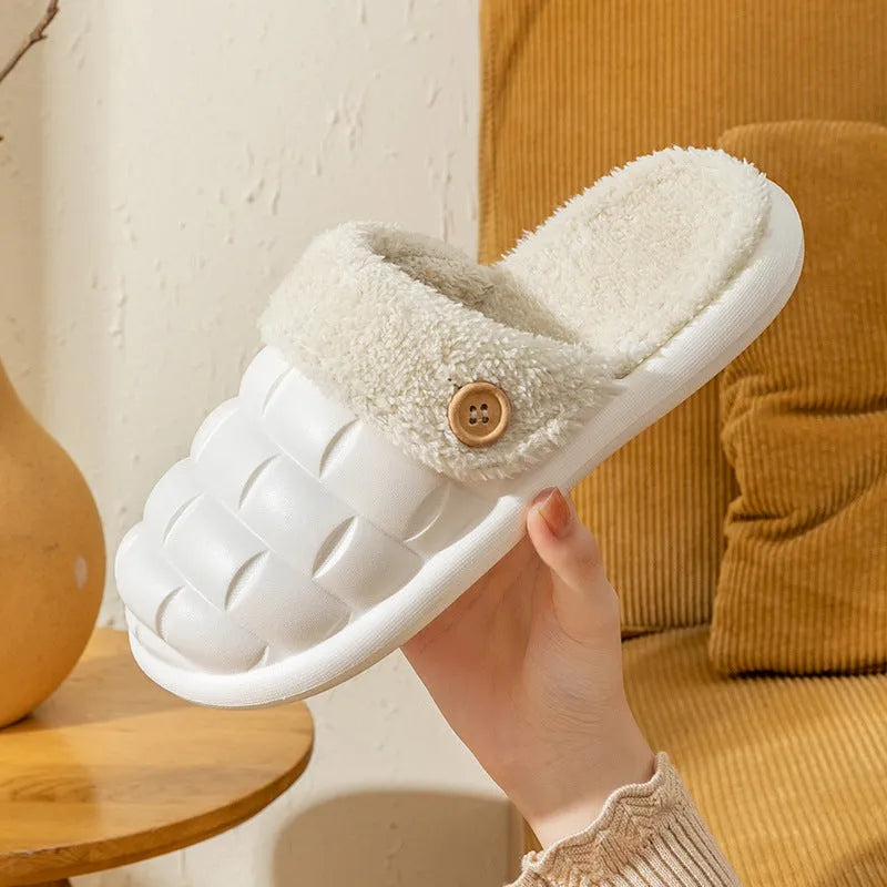 Women's pink and grey plaid EVA slippers with a detachable upper and plush lining on a wooden floor.